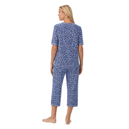 Navy Animal;Model is wearing size S. She is 5'9", Bust 34", Waist 26", Hips 36".@ A lady wearingCuddl Smart Elbow Sleeve Top with Cropped Pant Pajama Set with Navy Animal print