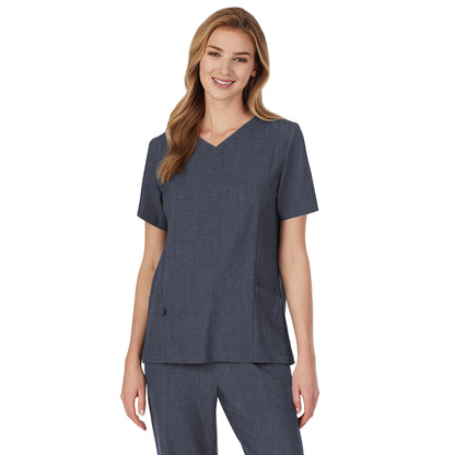 Navy Heather;A lady wearing navy heather scrub v-neck top with side pockets petite.