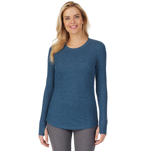 Peacock Blue Heather;Model is wearing size S. She is 5’9”, Bust 32”, Waist 25”, Hips 35”.@A lady wearing stretch thermal long sleeve crew.