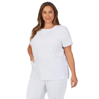 White;Model is wearing size 1X. She is 5’9.5”, Bust 43”, Waist 37”, Hips 49.5”.@A lady wearing white scrub henley neck top with side pockets plus.