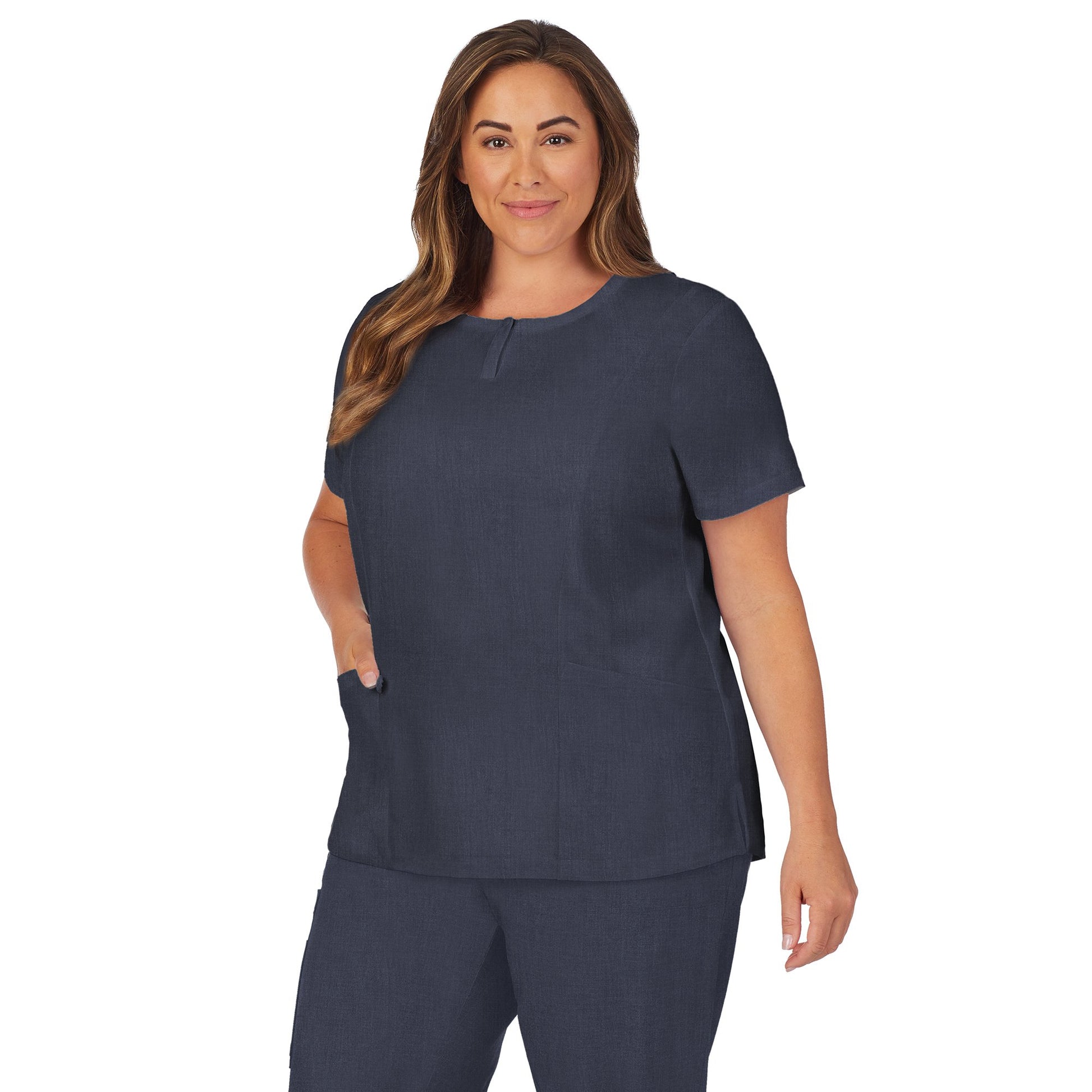 Navy Heather;Model is wearing size 1X. She is 5’9.5”, Bust 43”, Waist 37”, Hips 49.5”.@A lady wearing navy heather scrub henley neck top with side pockets plus.