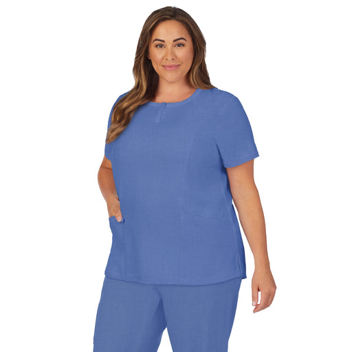 Ceil Heather;Model is wearing size 1X. She is 5’9.5”, Bust 43”, Waist 37”, Hips 49.5”.@A lady wearing ceil heather scrub henley neck top with side pockets plus.