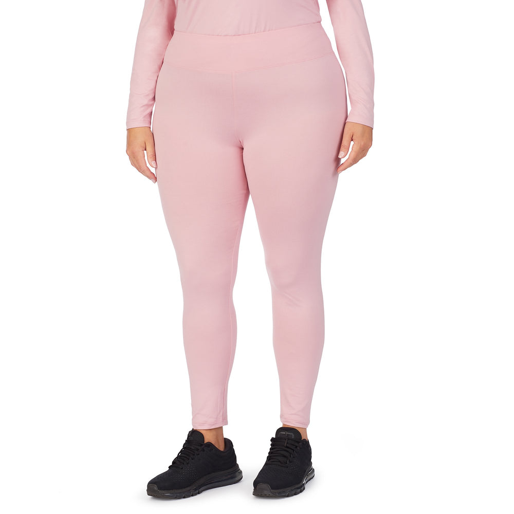 A lady wearing Pink underscrub legging plus.