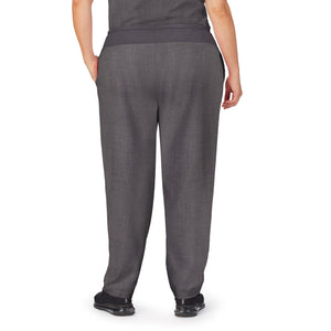 A lady wearing charcoal heather scrub classic pant plus.