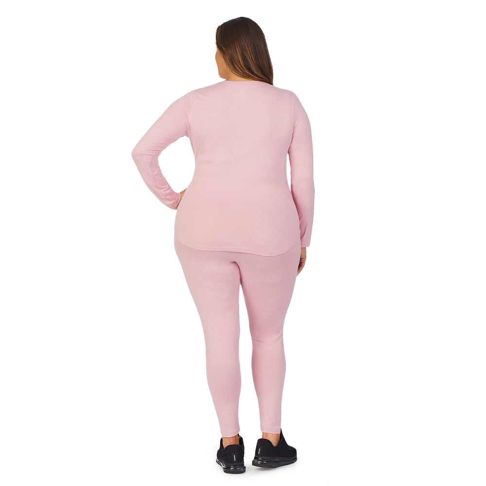 A lady wearing Pink underscrub legging plus.