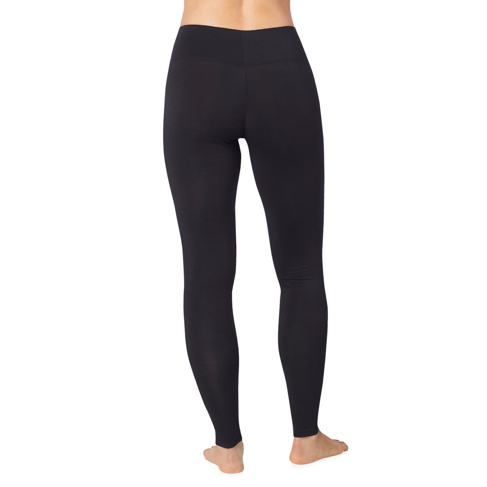 A lady wearing black high waist legging petite.