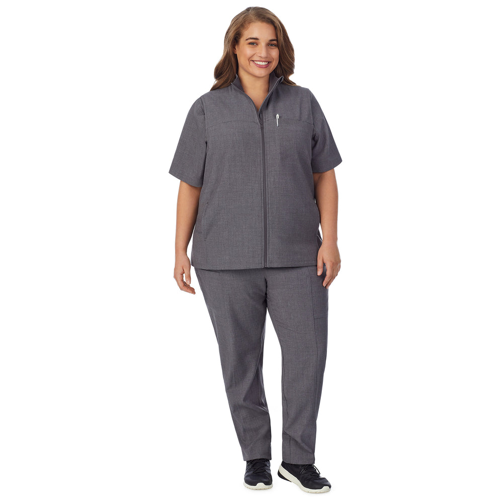 A lady wearing charcoal heather scrub vest plus.