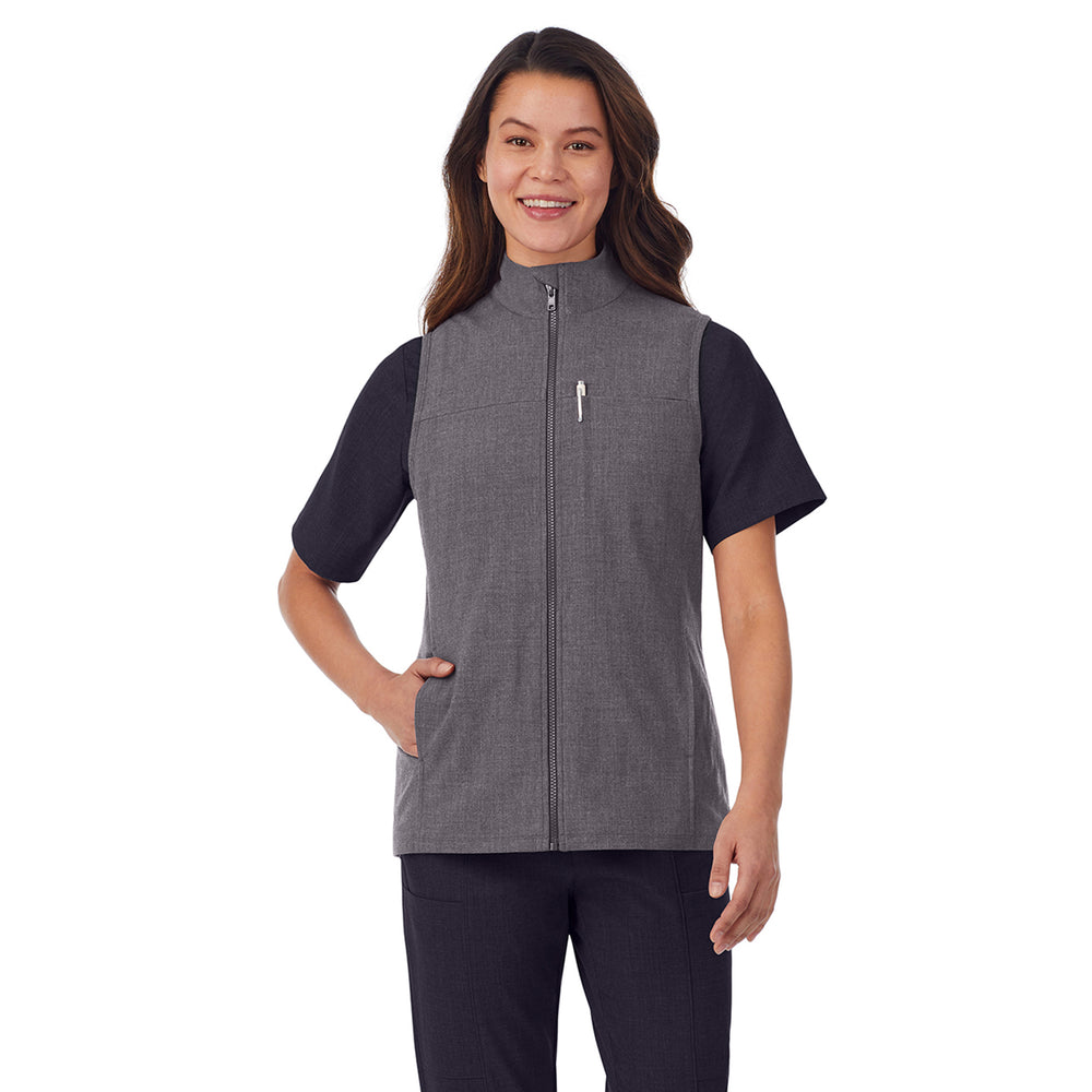 A lady wearing charcoal heather scrub vest.