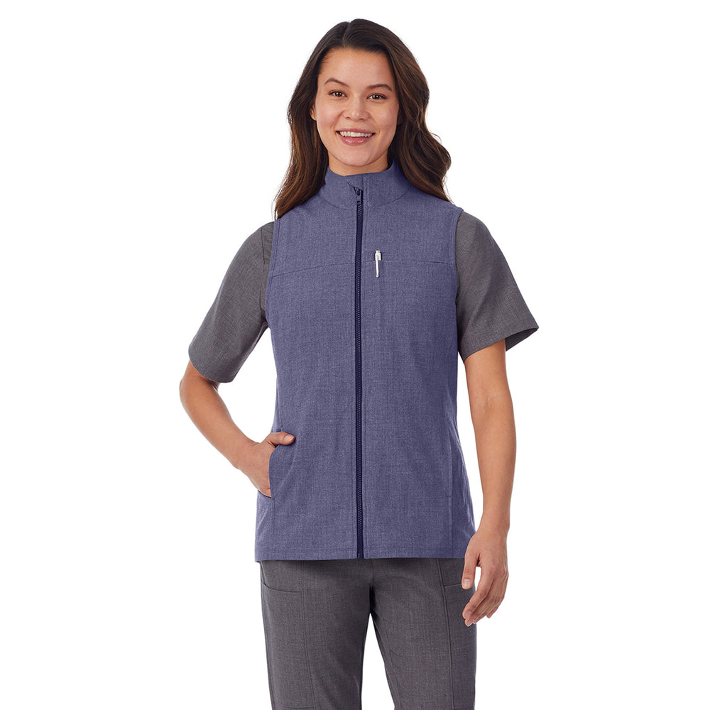 A lady wearing navy heather scrub vest.