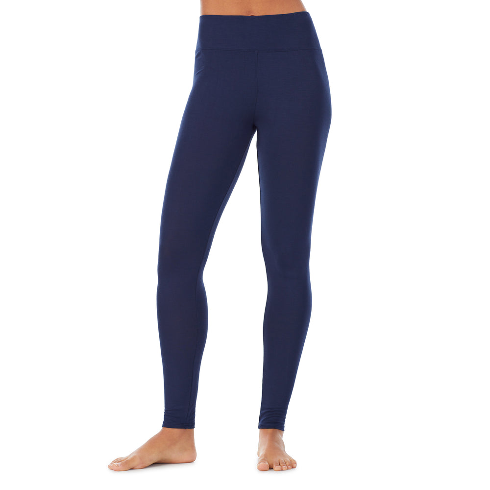 A lady wearing a dress blue high waist legging.