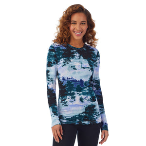 A lady wearing a green misty forest long sleeve stretch crew PETITE.