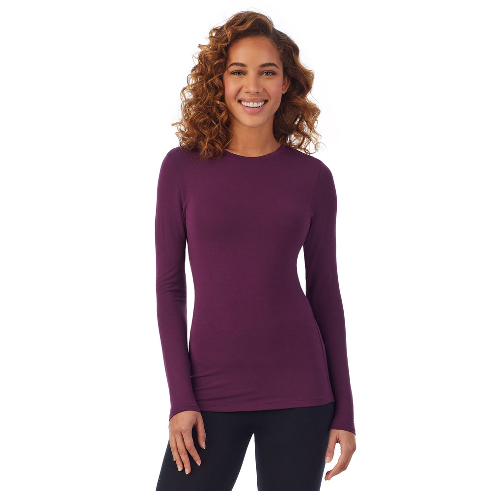 A lady wearing a grape long sleeve stretch crew PETITE.
