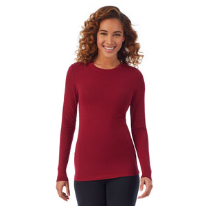 A lady wearing a rhubarb long sleeve stretch crew PETITE.