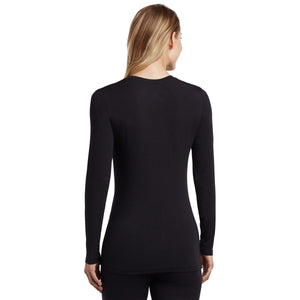 A lady wearing a black long sleeve stretch crew tall.