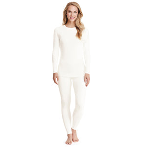 A lady wearing a ivory long sleeve stretch crew tall.