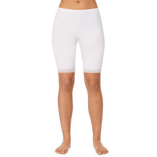 A lady wearing a white lace edge short.