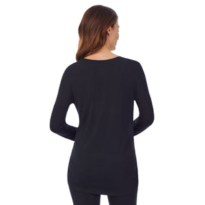 A lady wearing a black long sleeve maternity snap front henley top. #Model is wearing a maternity bump.