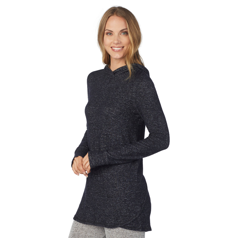 A lady wearing a marled dark charcoal long sleeve tunic hoodie.