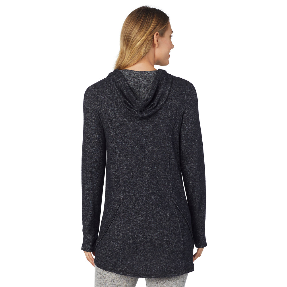 A lady wearing a marled dark charcoal long sleeve tunic hoodie.