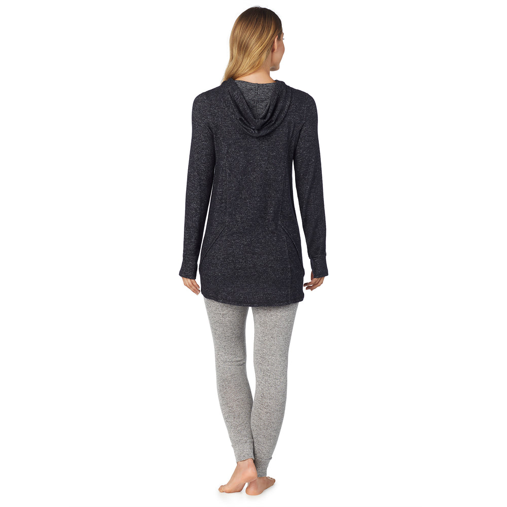 A lady wearing a marled dark charcoal long sleeve tunic hoodie.