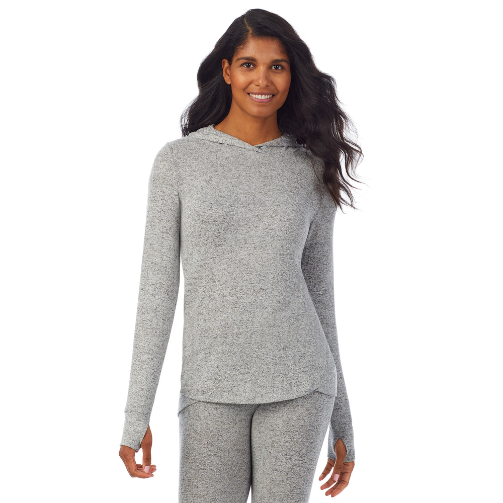 A lady wearing a marled grey long sleeve tunic hoodie.