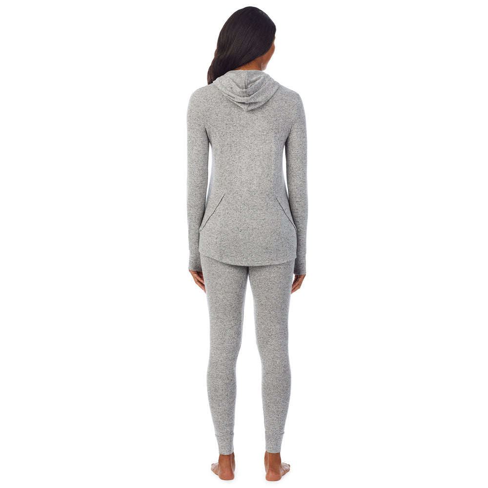 A lady wearing a marled grey long sleeve tunic hoodie.