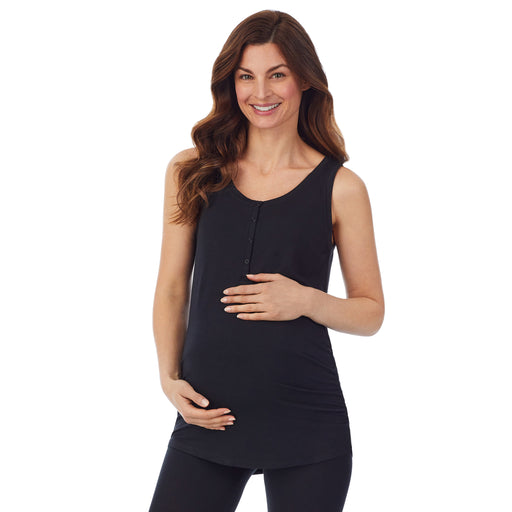 A lady wearing a black sleeveless maternity snap front henley tank top. 