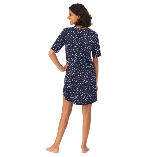 Navy Ditsy Heart; Model is wearing size S. She is 5’9”, Bust 32”, Waist 24”, Hips 34.5”. @A lady wearing elbow sleeve blue sleep shirt with heart shaped print