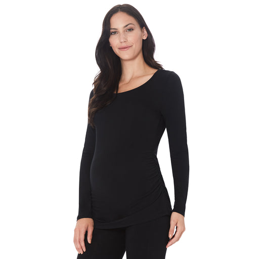 A lady wearing a black long sleeve maternity ballet neck top. 