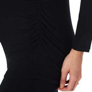 A lady wearing a long sleeve black maternity ballet neck top. #Model is wearing a maternity bump.