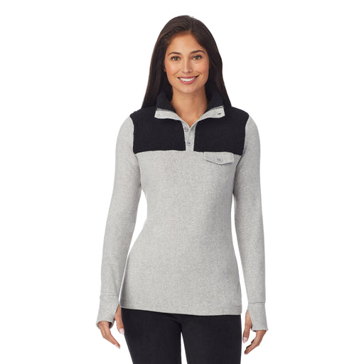 upper body of a lady wearing grey long sleeve mixed media mock