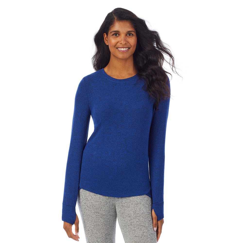 A lady wearing a marled royal blue  long sleeve crew.