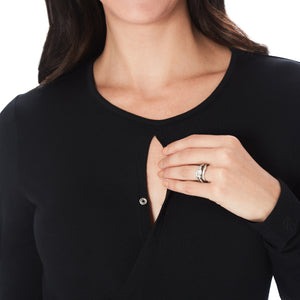 A lady wearing a black long sleeve maternity wrap front top. #Model is wearing a maternity bump.