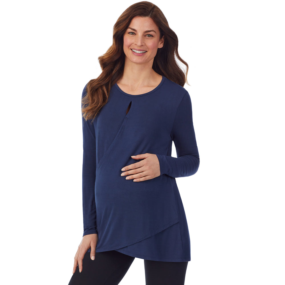 A lady wearing a dress blue long sleeve maternity wrap front top. #Model is wearing a maternity bump.