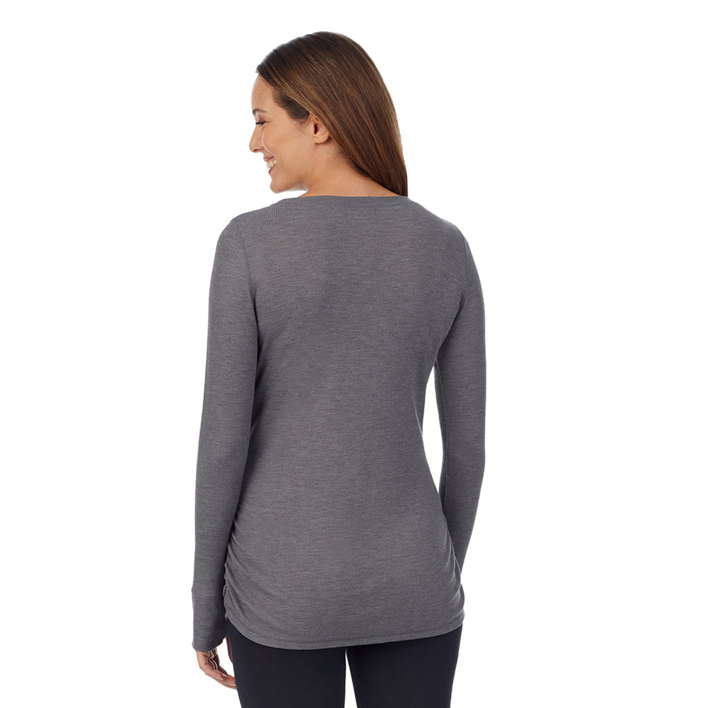 A lady wearing a stone grey heather long sleeve maternity ballet neck top. #Model is wearing a maternity bump.