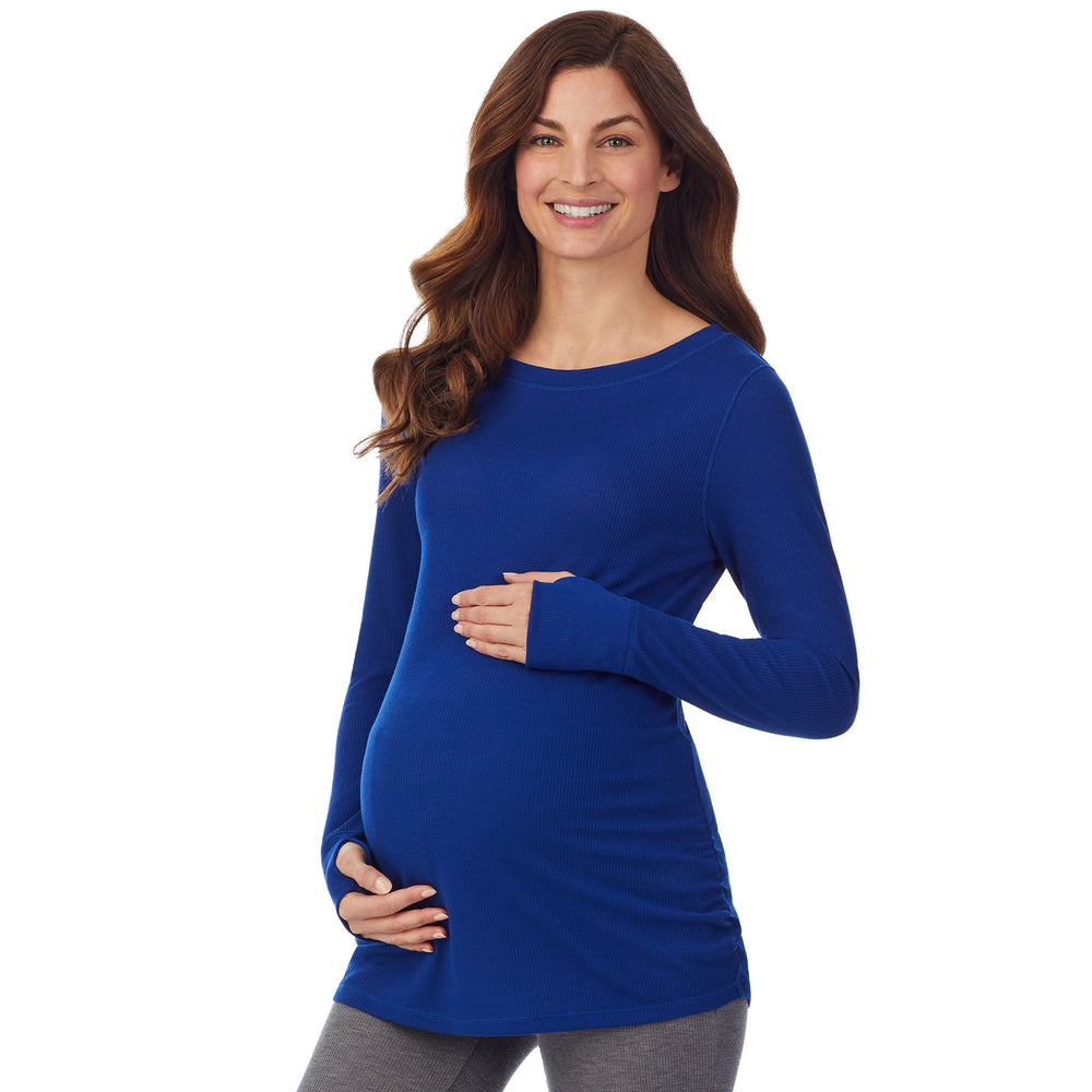 A lady wearing a royal blue long sleeve maternity ballet neck top. #Model is wearing a maternity bump.