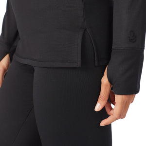 A lady wearing a  black long sleeve crew.