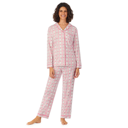 A lady wearing a long sleeve pajama set with pink geo pattern.