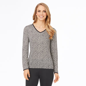 A lady wearing a cheetah long sleeve lace edge V-Neck.