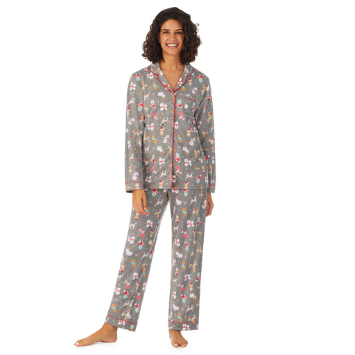 A lady wearing a grey  long sleeve pajama set with dogs pattern.