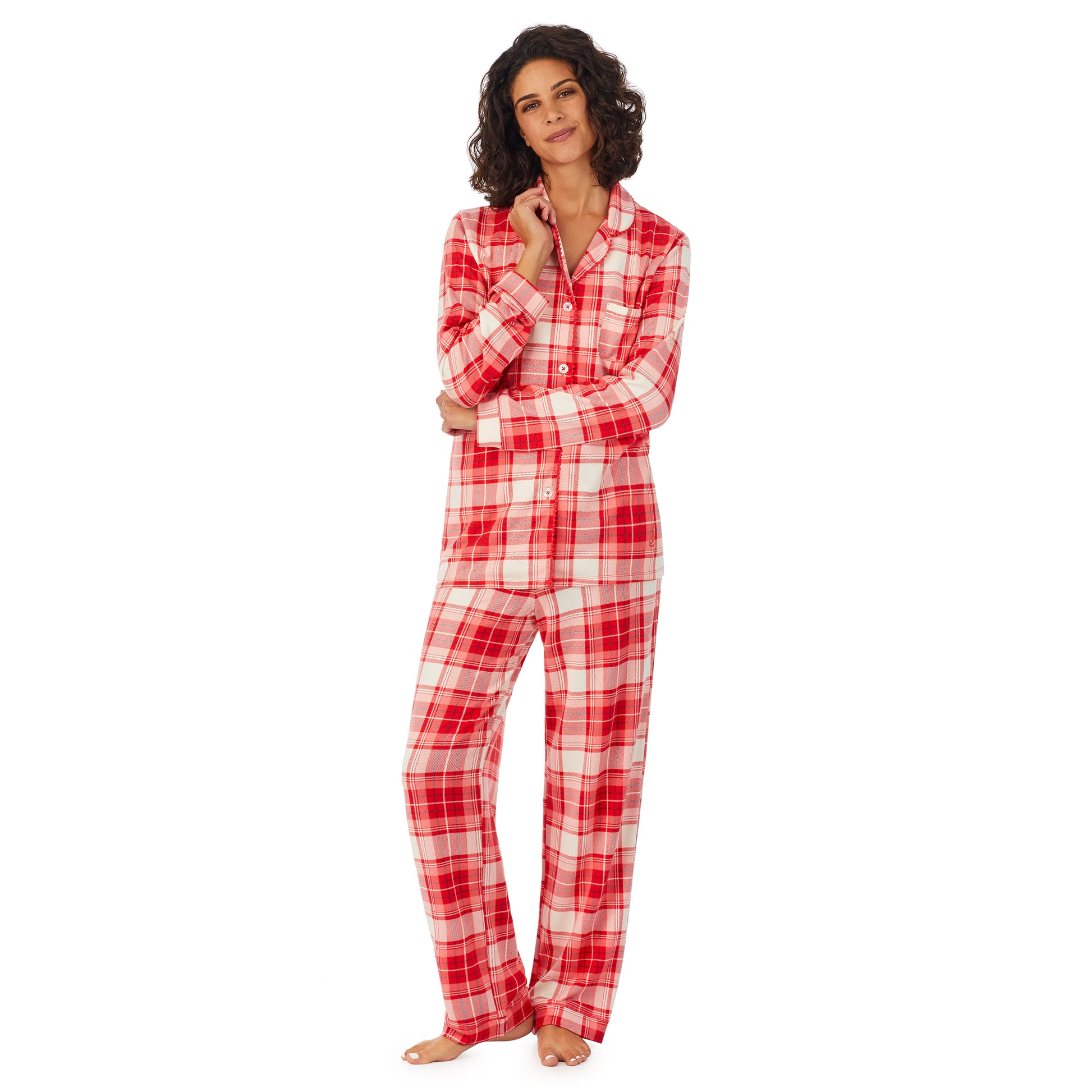 A lady wearing a white long sleeve pajama set with red ivory plaid.