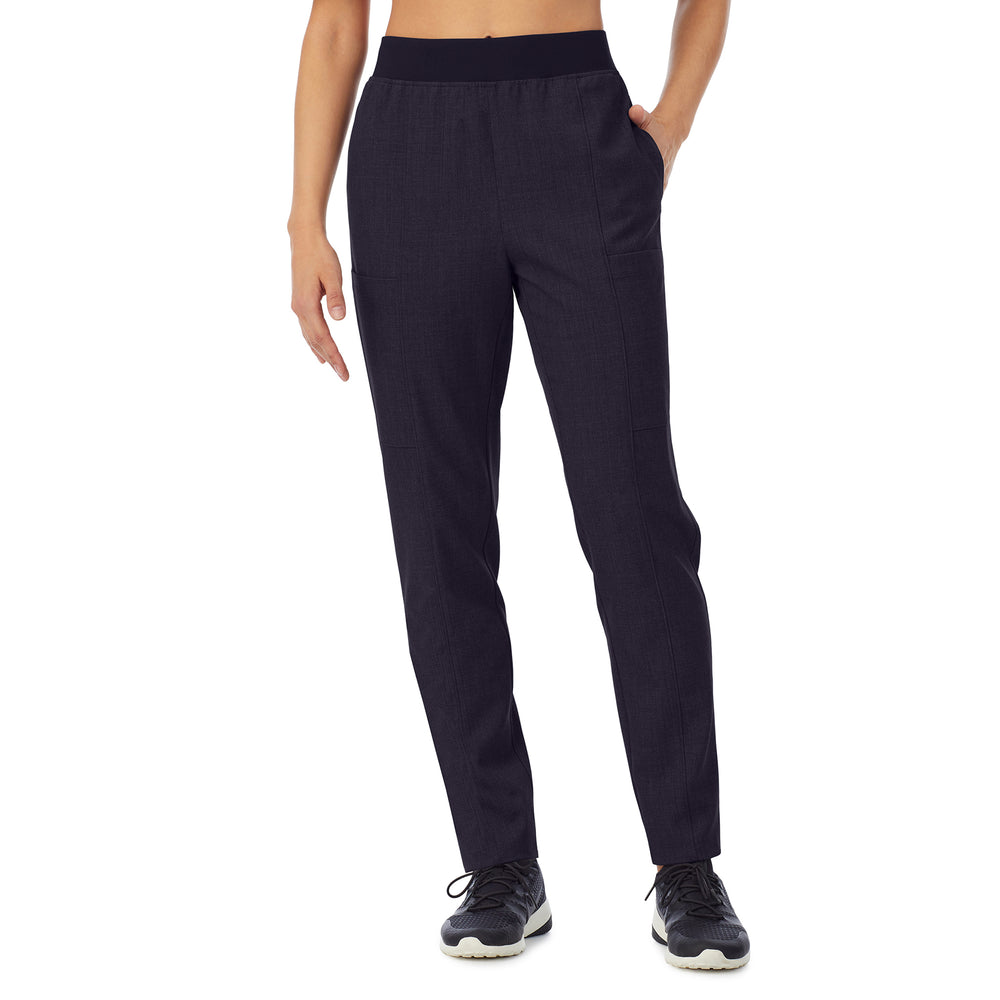 A lady wearing black scrub slim cargo pant petite.