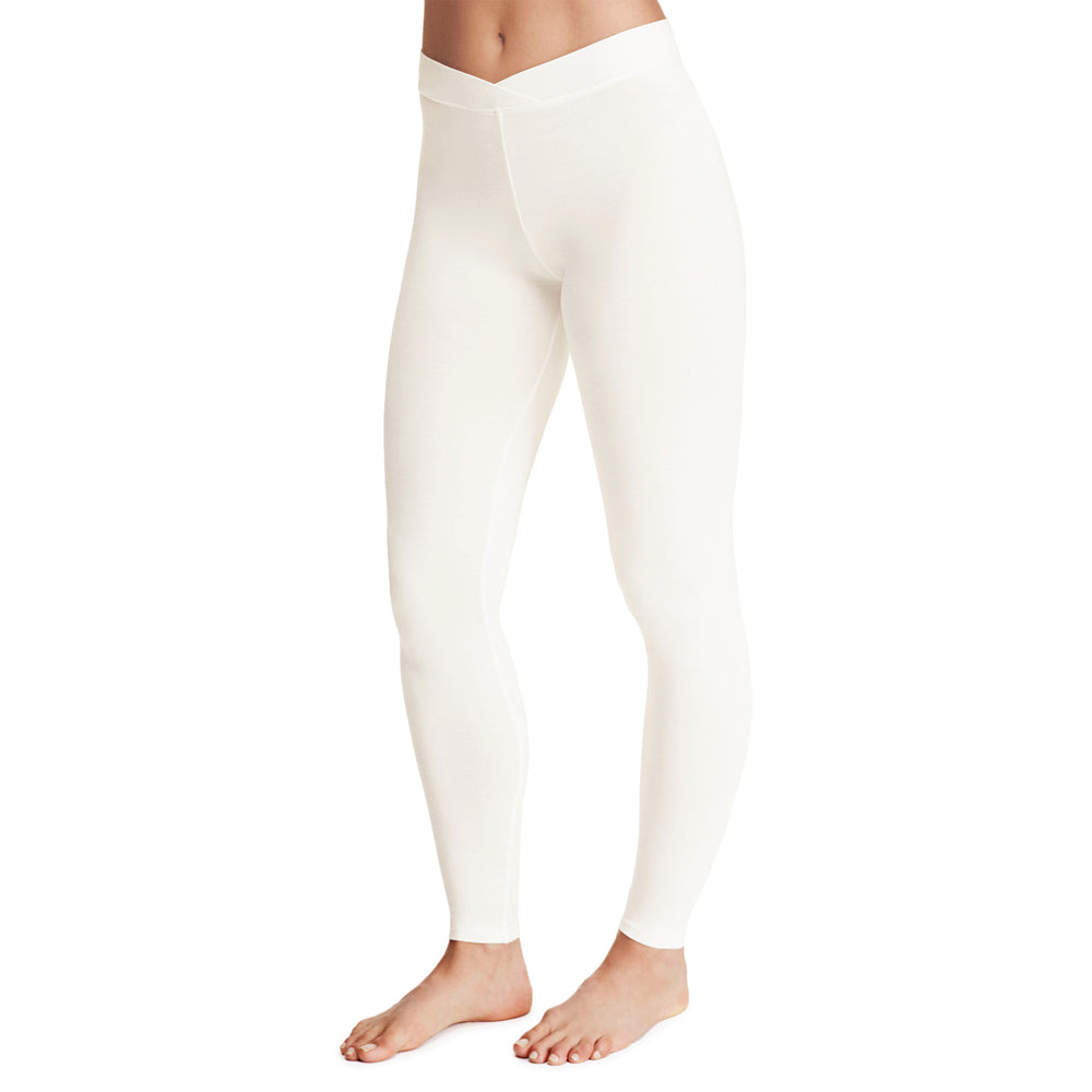 A lady wearing a ivory stretch legging.