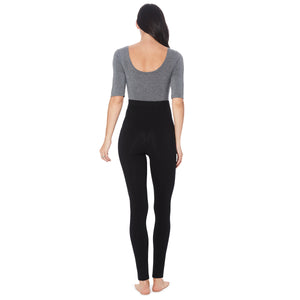 A lady wearing a black maternity legging. #Model is wearing a maternity bump.