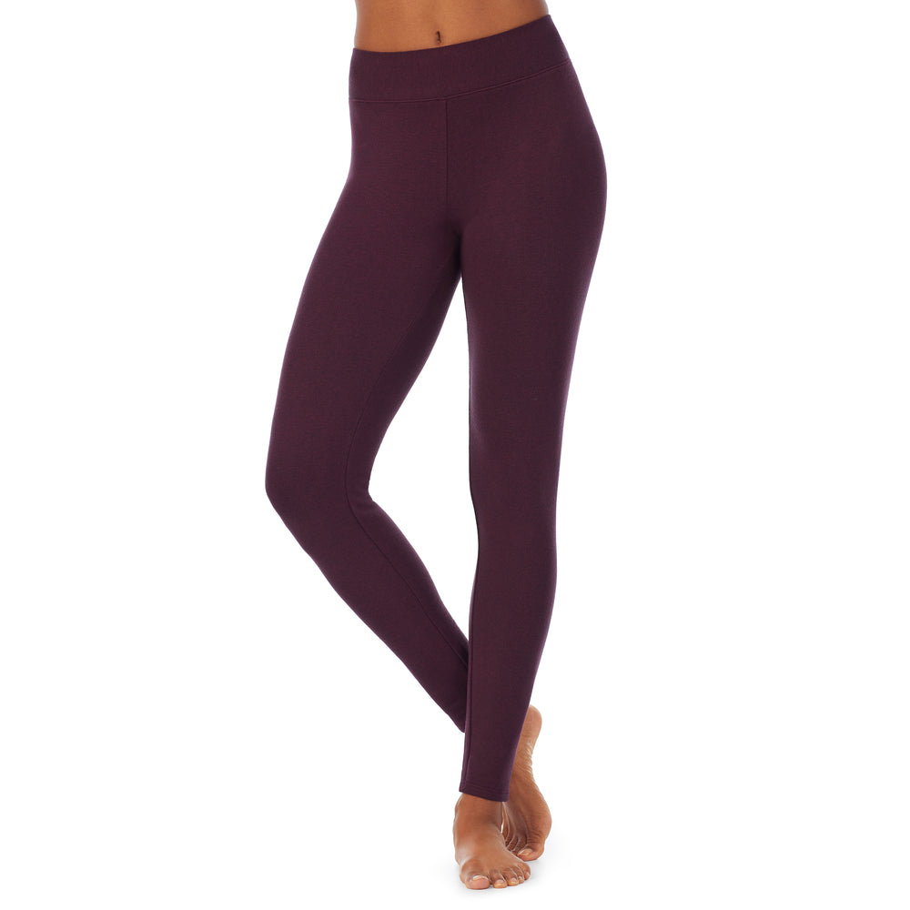 A lady wearing a grape heather legging.