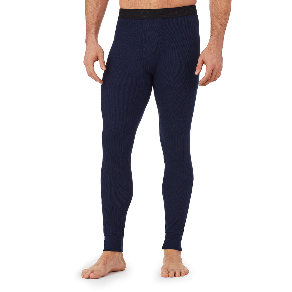 A man wearing a navy waffle thermal pant.