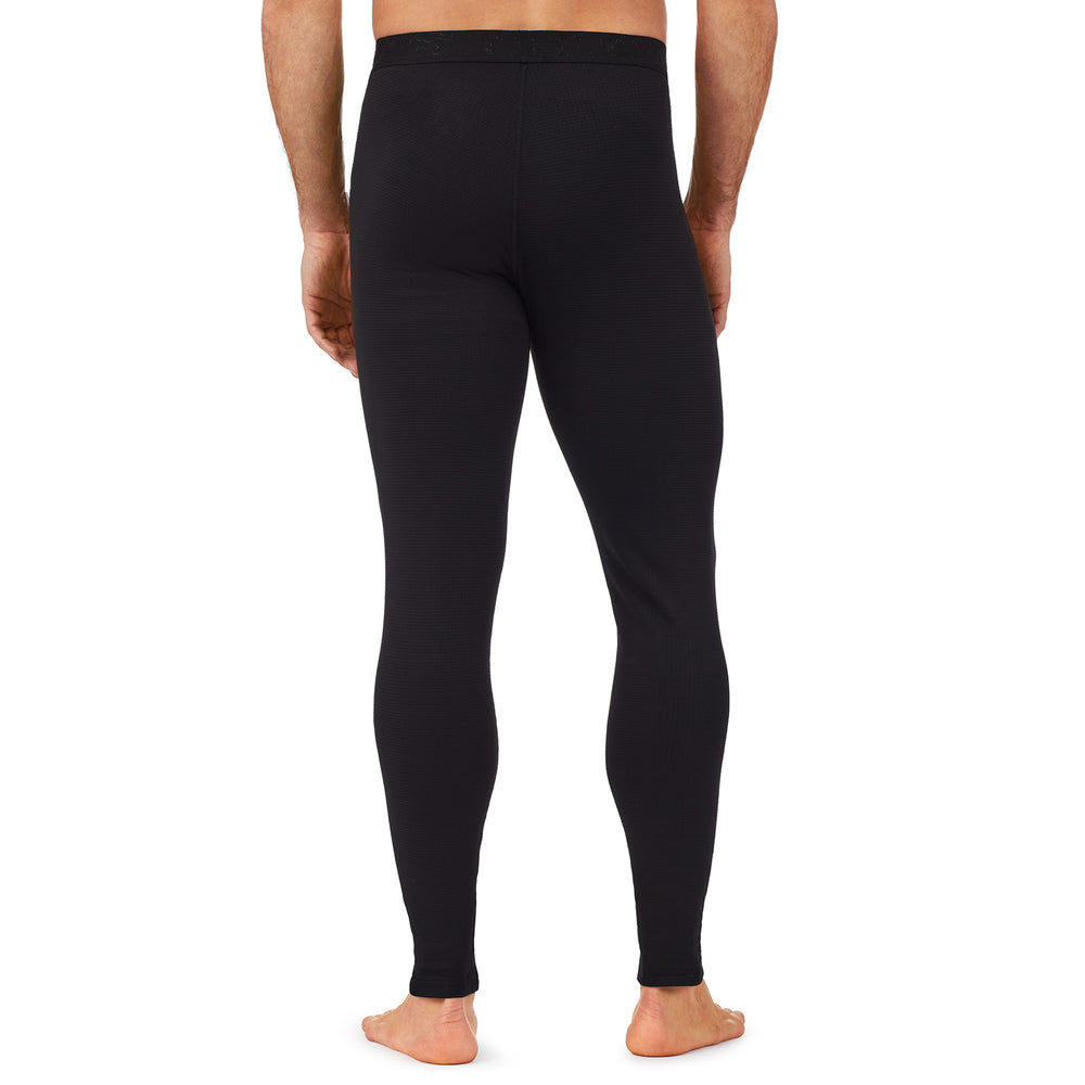 A man wearing a black X fleece pant.