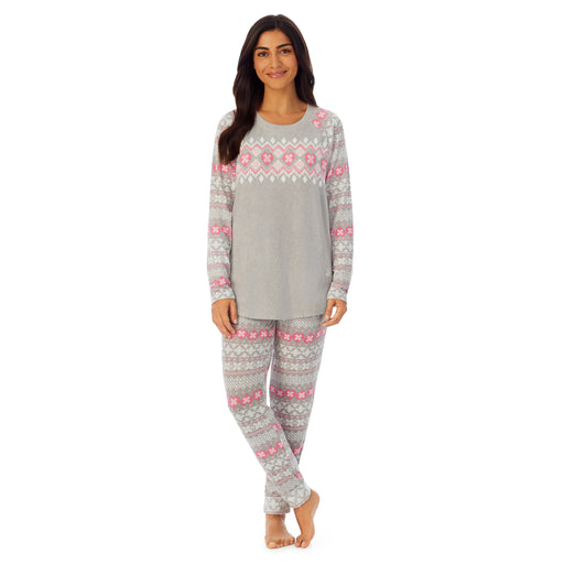 A lady wearing grey long sleeve pajama set with white and pink print