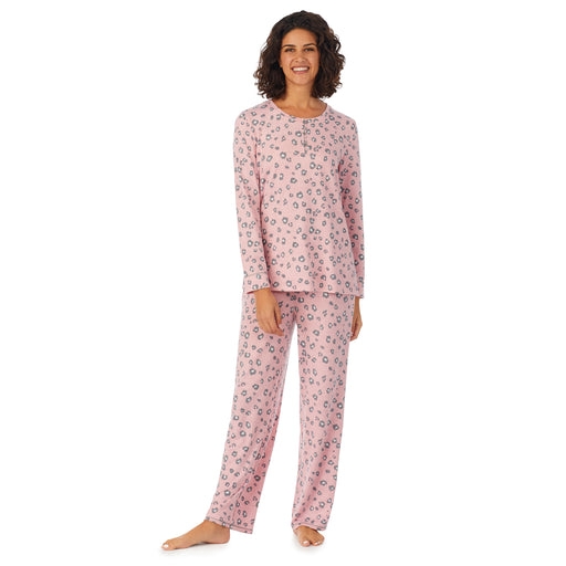 A lady wearing a pink long sleeve pajama set with pop animal pattern.