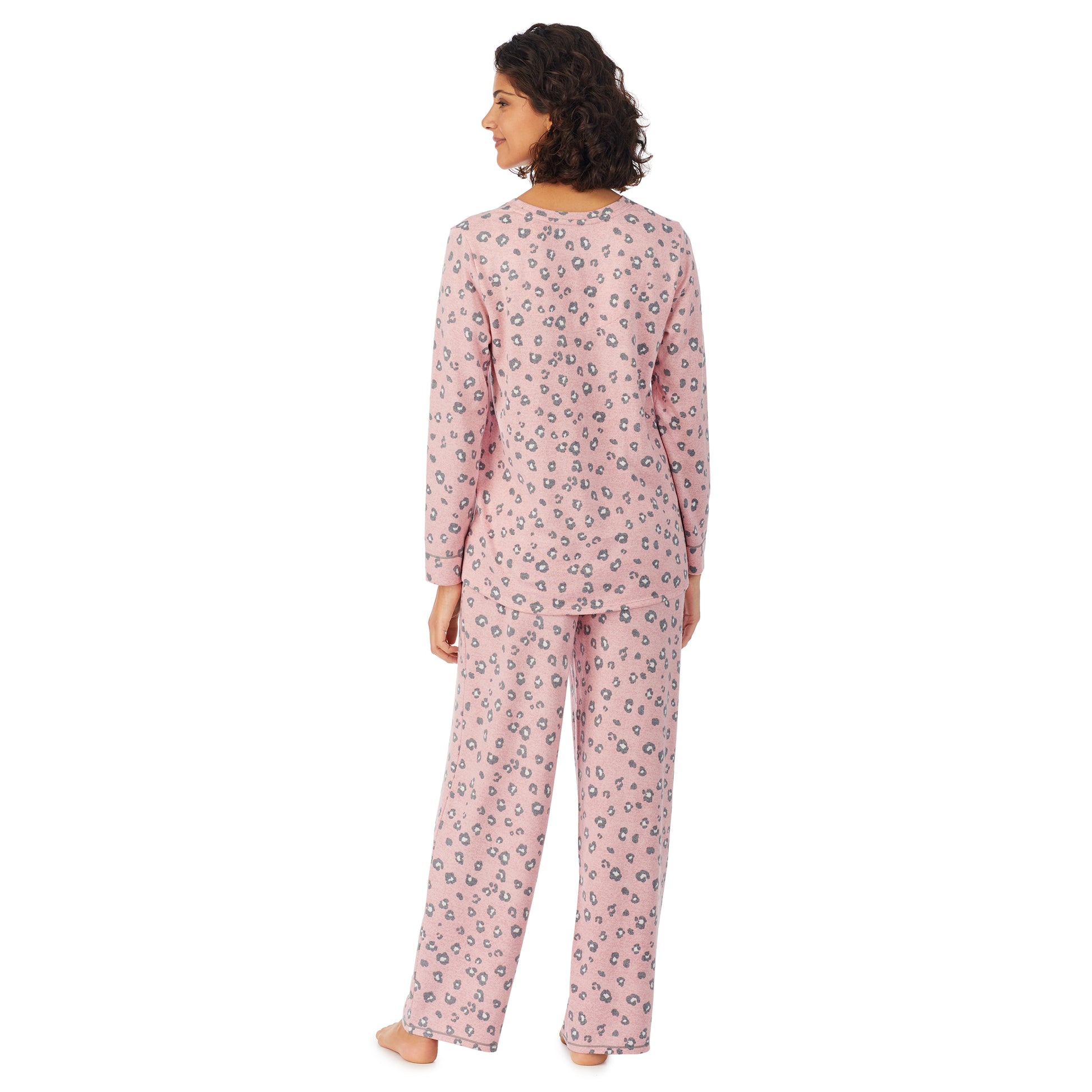 A lady wearing a pink long sleeve pajama set with pop animal pattern.